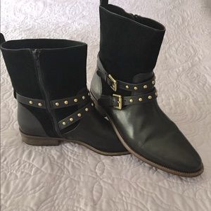 Black Coach boots with gold buckles and stud accents